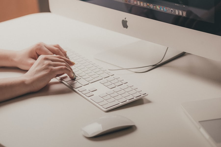 decorative image of an iMac and keyboard