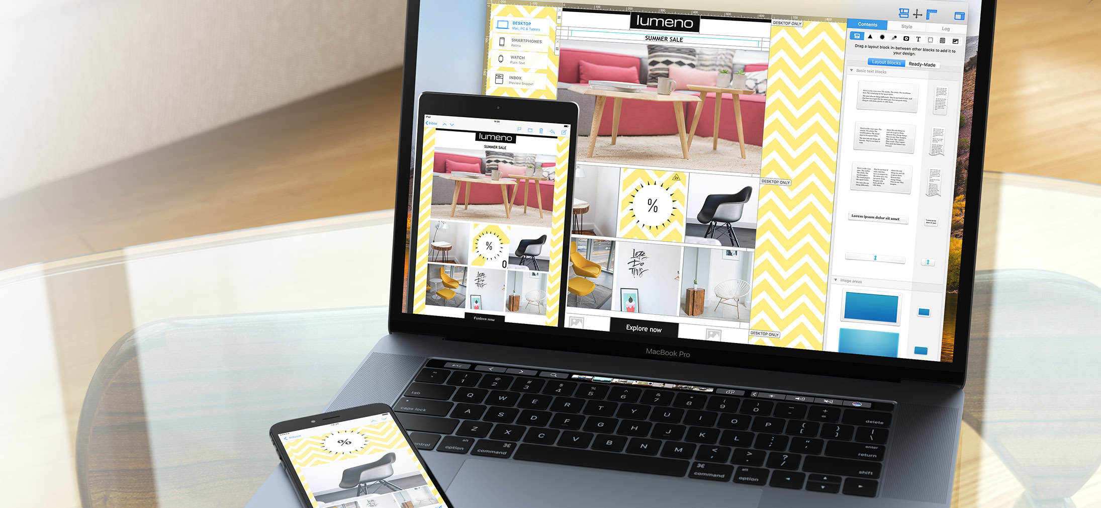 A close-up view of a MacBook Pro displaying the Mail Designer 365 software interface for creating email templates. On the laptop screen, a "SUMMER SALE" email design is visible, featuring furniture imagery and yellow chevron patterns. In the foreground, an iPad and an iPhone also display the same email template, demonstrating the software's responsive design capabilities across multiple devices. An email design software, Mail Designer 365, being used on a MacBook Pro to create a "Summer Sale" email template. The software interface shows various design elements and a preview of the email on both desktop and mobile devices (a tablet and a smartphone are also visible), demonstrating its responsive design capabilities.